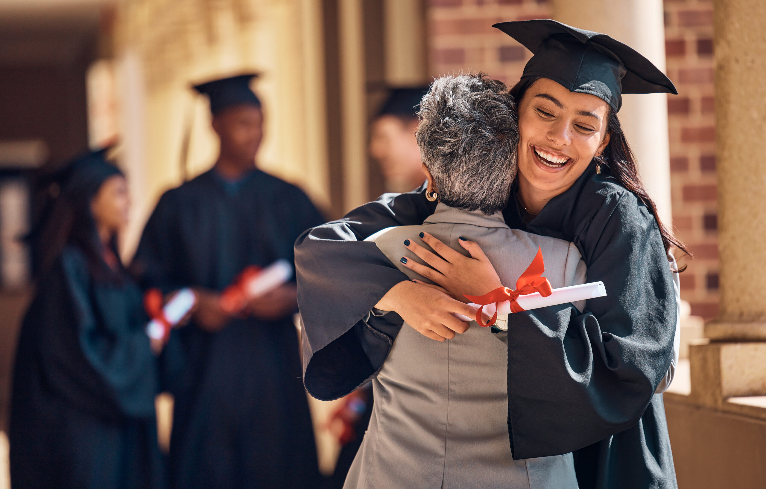 Hug, graduation and graduate, women and education achievement, success on university campus and certificate with academic goals reached. College, student and graduating ceremony, event and degree